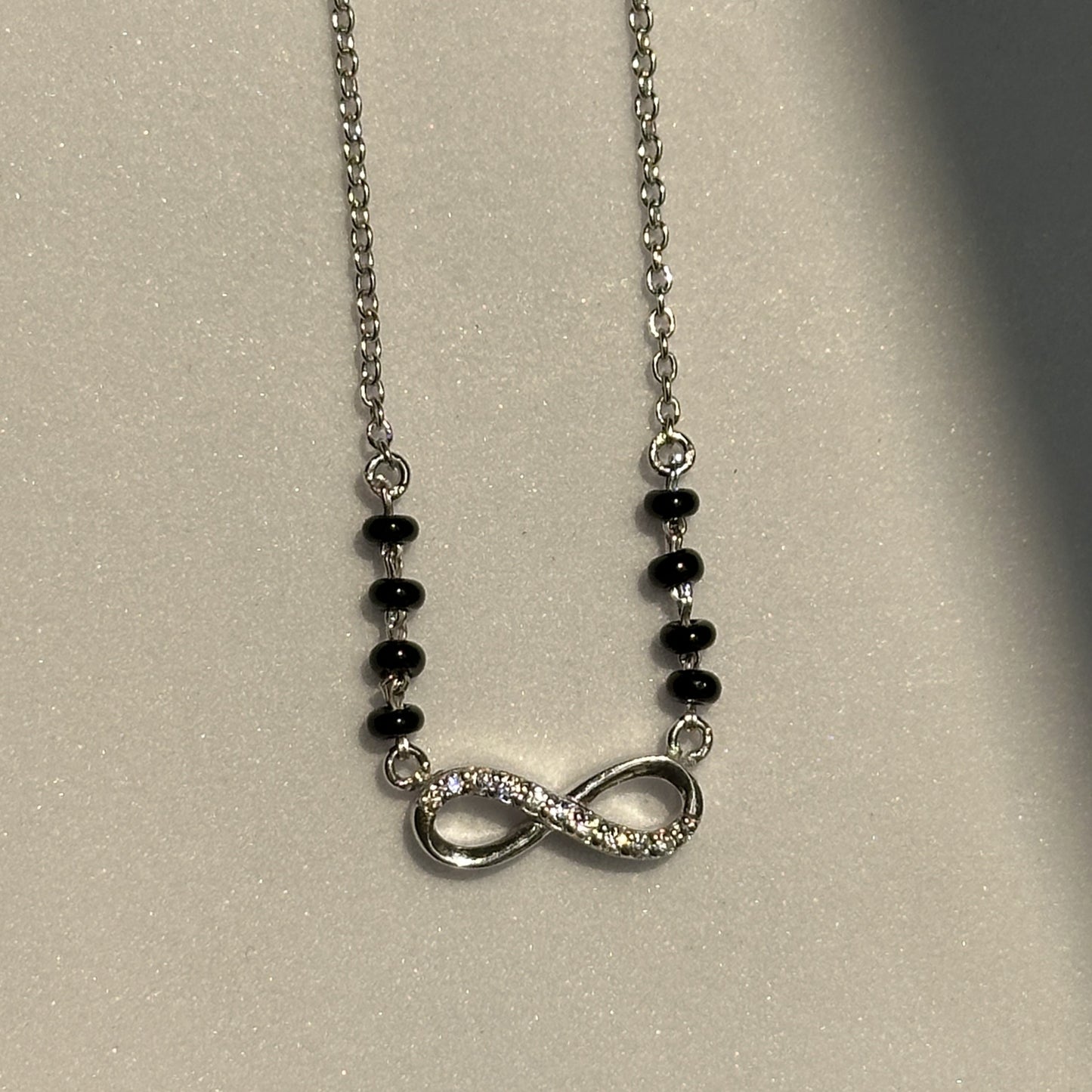 infinity grace mangalsutra — infinity motif in 925 silver with black beads