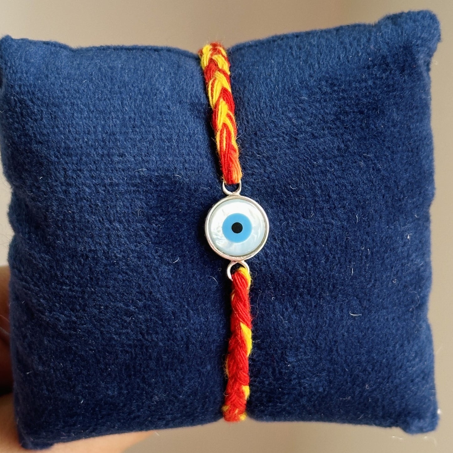 eternal evil eye rakhi 10mm close-up — larger blue evil eye stone detail
