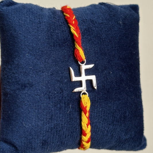 Blessed Swastik Rakhi tied on wrist — 925 silver swastik rakhi for Raksha Bandhan