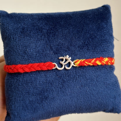 Om Blessing Rakhi close-up — silver Om charm detail