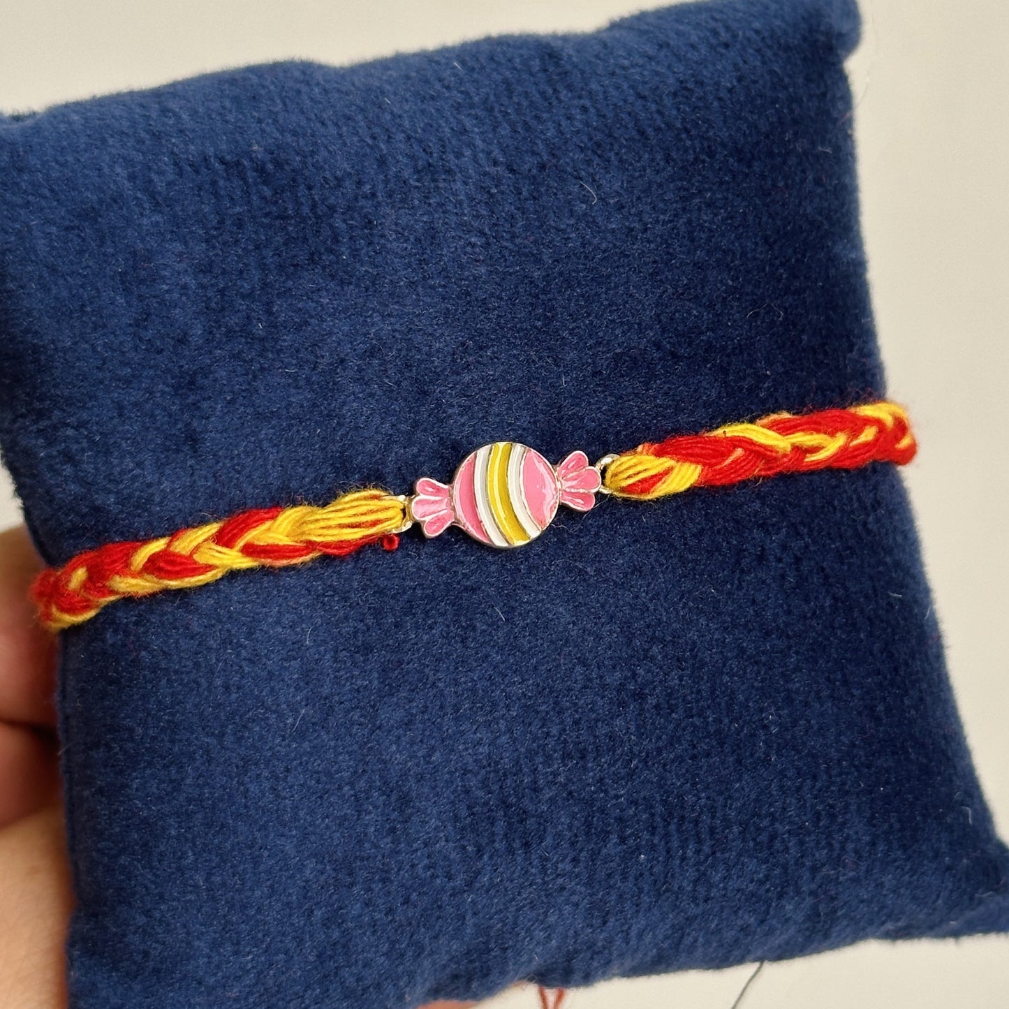 candy pop rakhi close-up — enamel candy motif detail