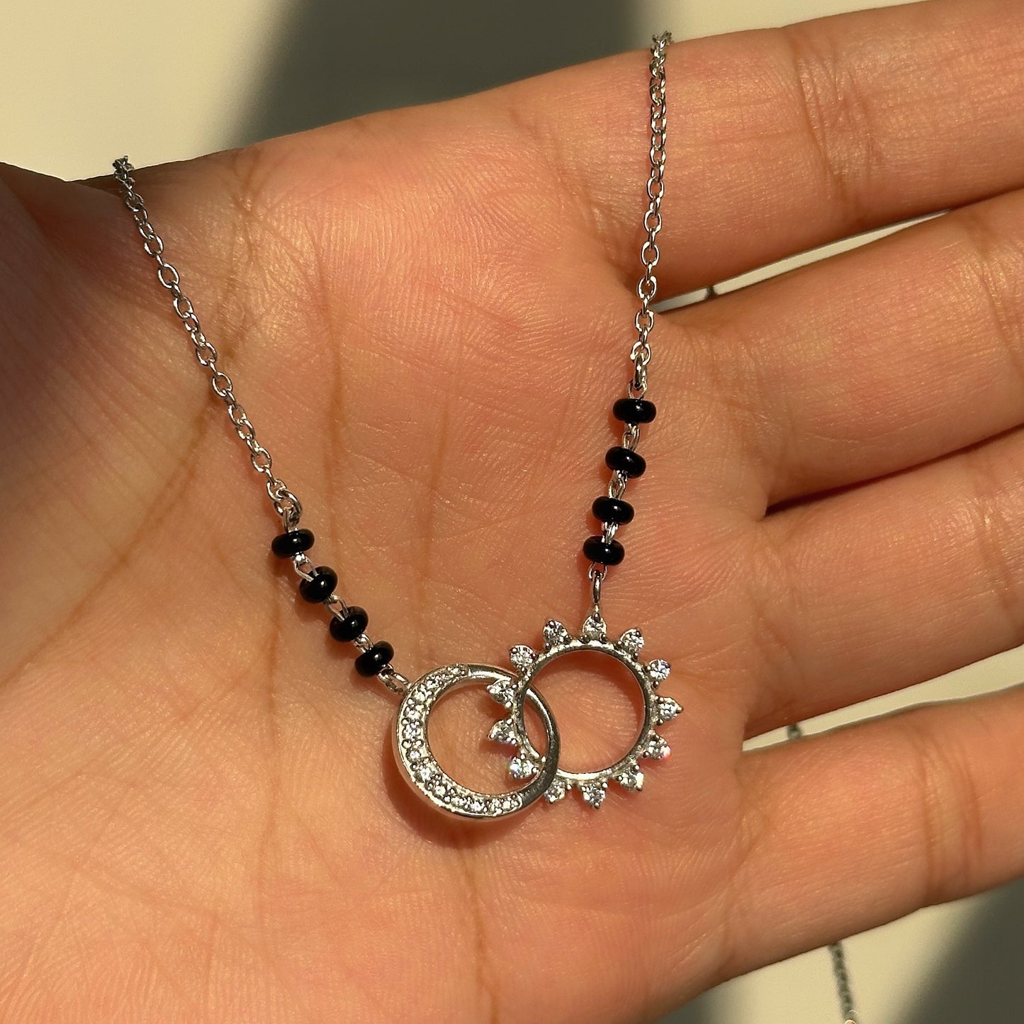 twin eclipse mangalsutra close-up — intertwined zircon-studded detail