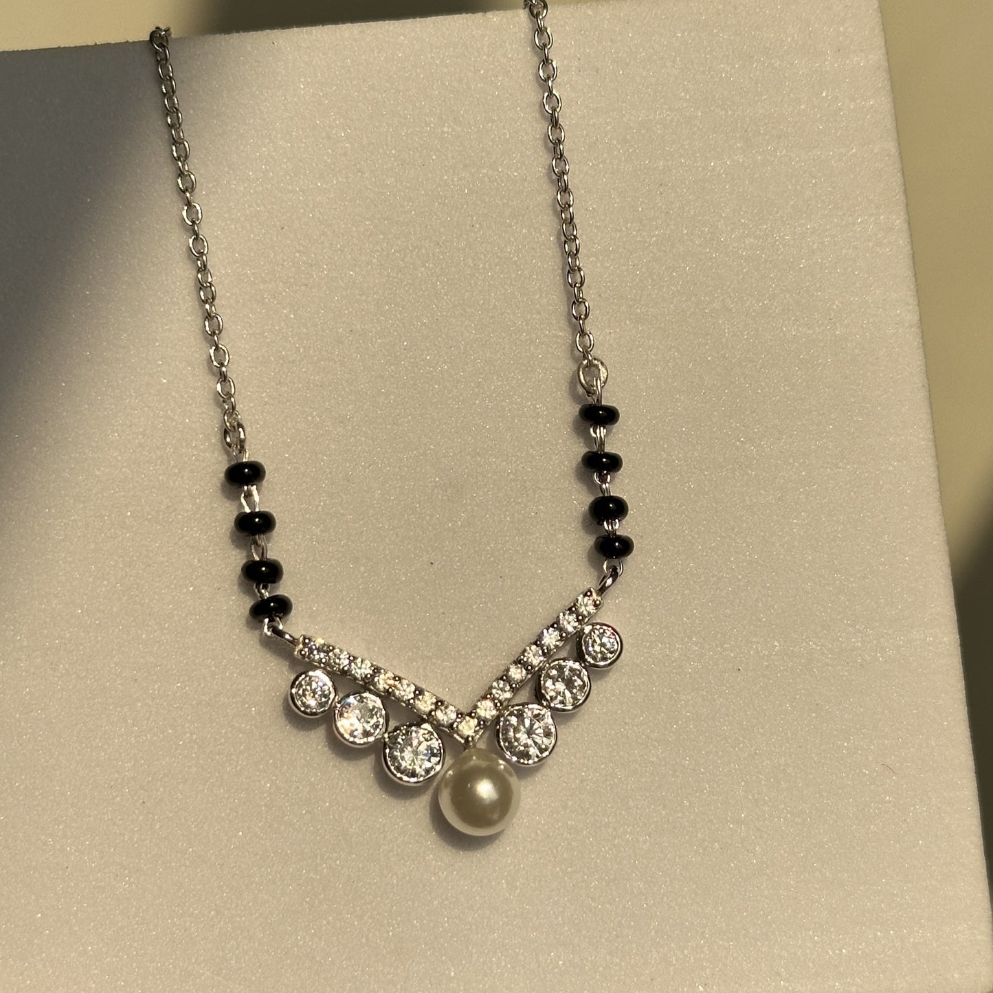 royal pearl mangalsutra close-up — pearl and zircon motif detail