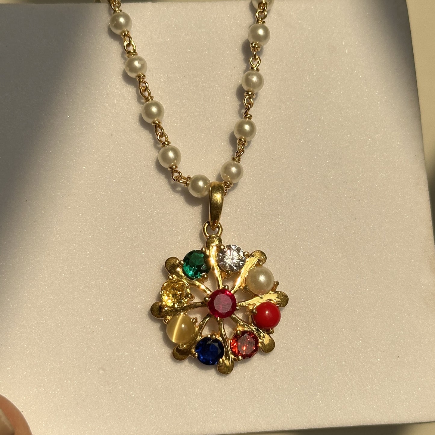 navratna pearl pendant close-up — nine coloured navratna stones in silver