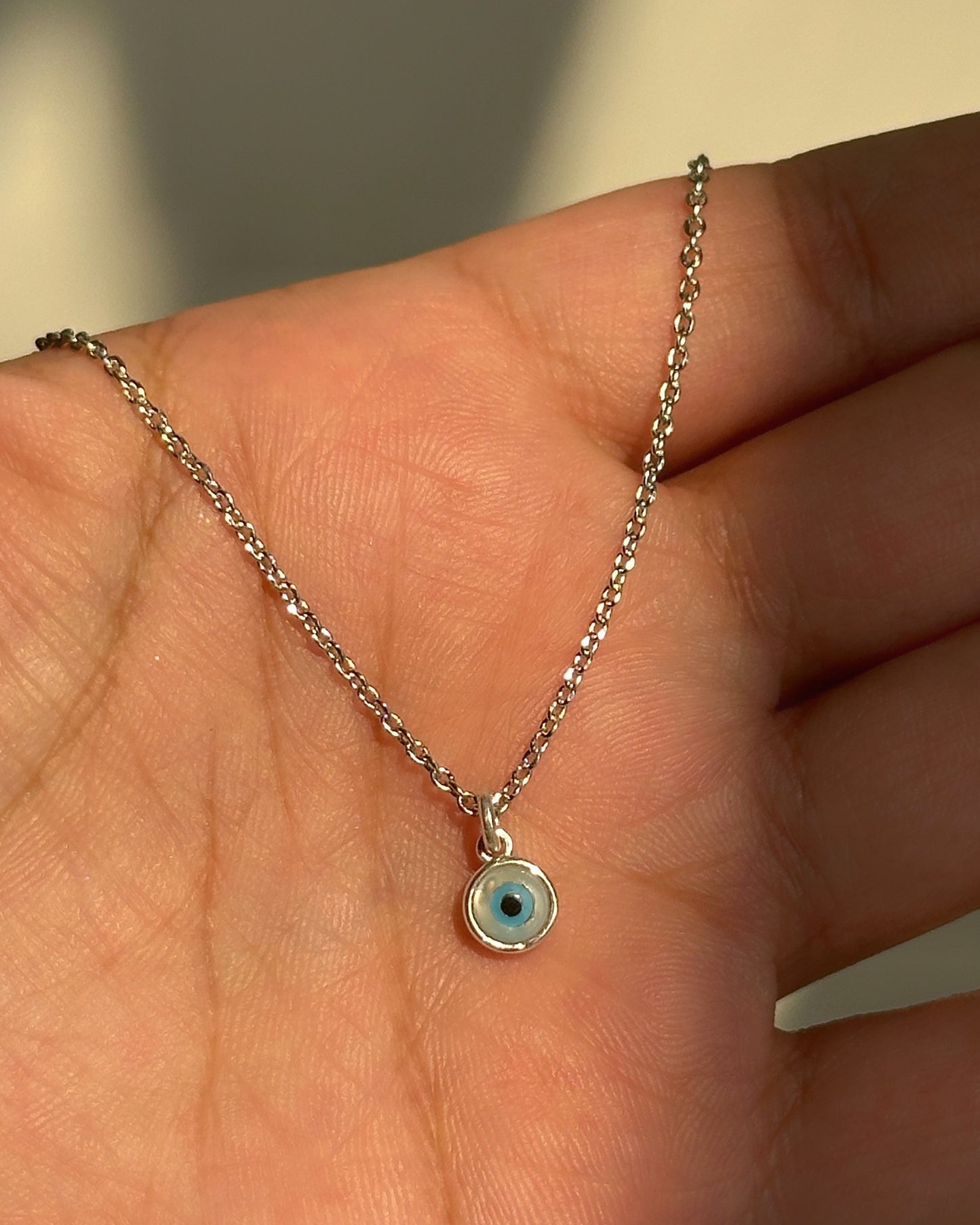 small evil eye neckpiece close-up — blue evil eye pendant detail