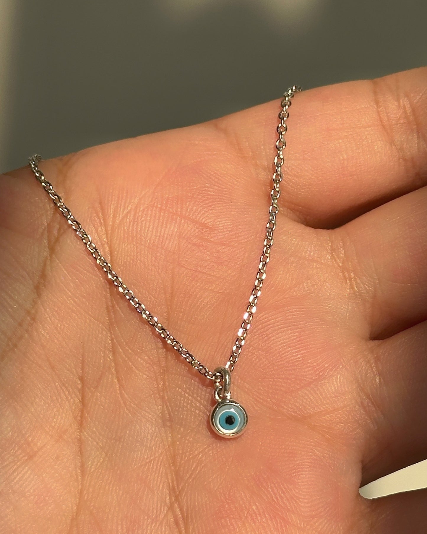 tiny evil eye neckpiece close-up — dainty blue evil eye pendant