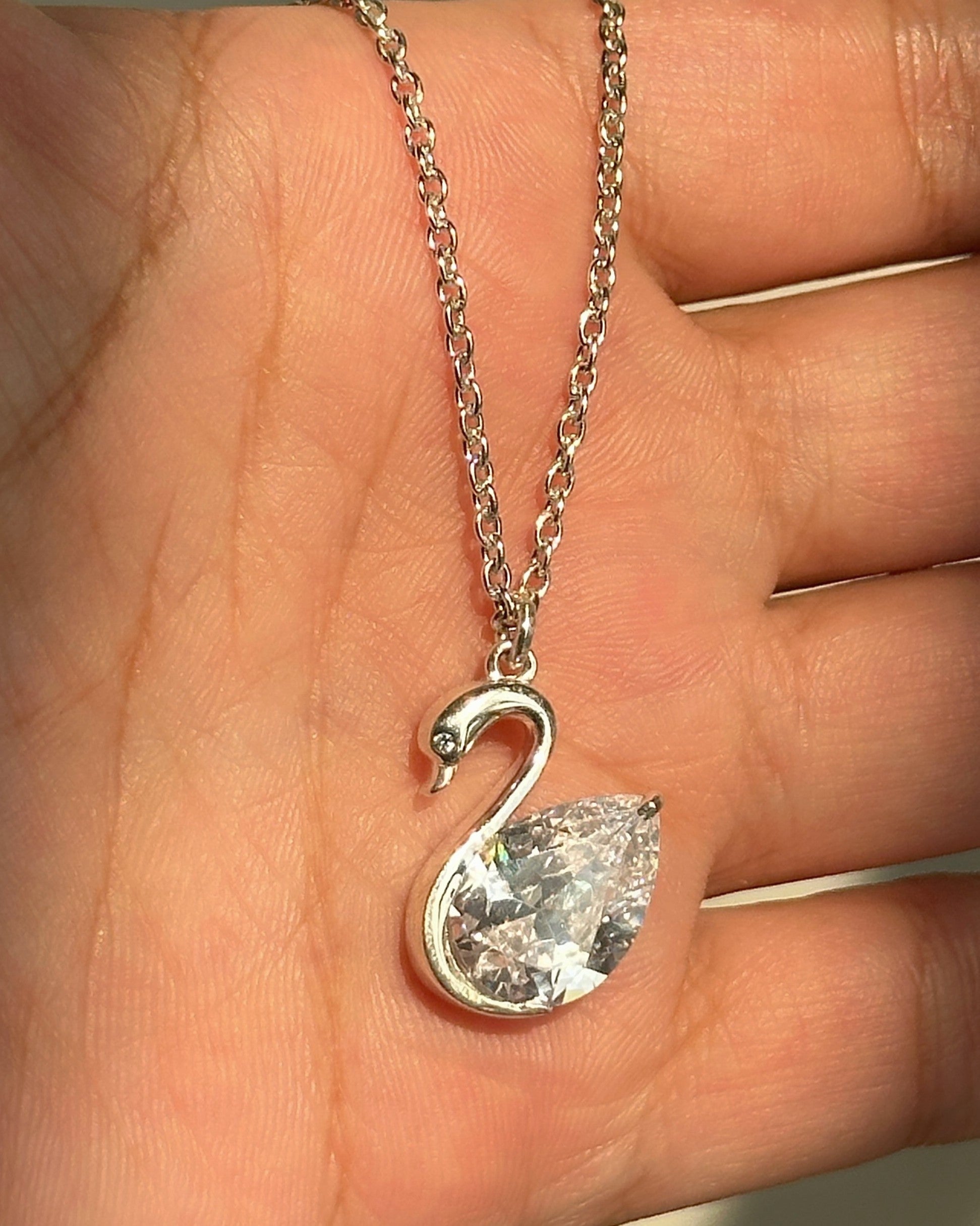 Celeste Swan Neckpiece close-up — silver swan and pear-cut stone detail