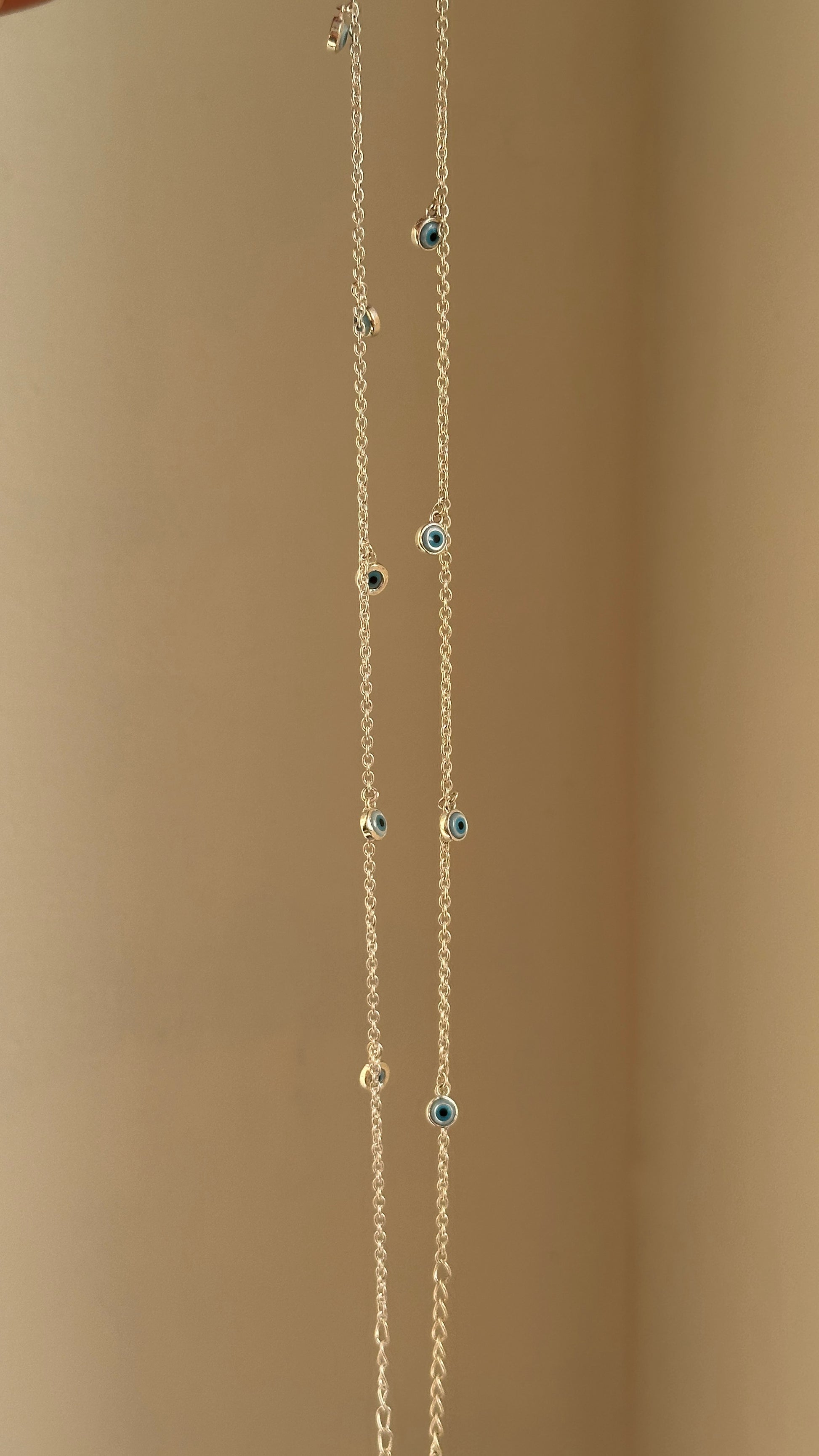 Evil Eye Dangle Anklet close-up — dangling blue evil eye charms
