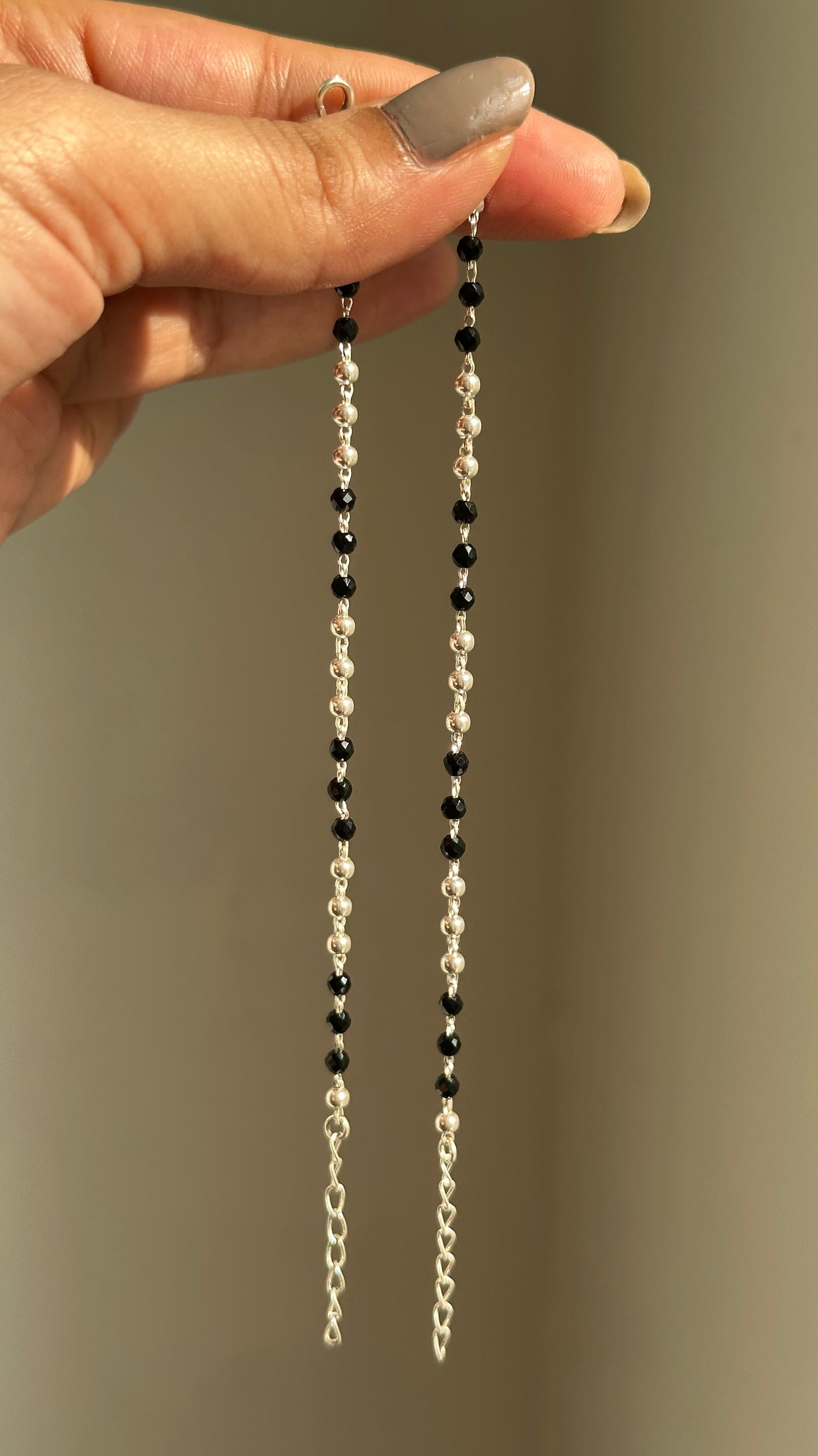 tiny black bead anklet on a child's ankle — nazariya black bead payal